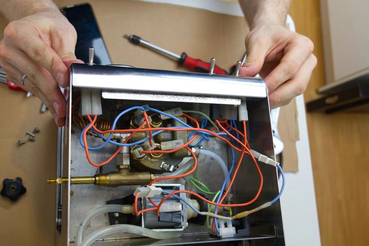 Close-up of somebody repairing a coffee machine