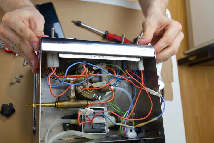 Close-up of somebody repairing a coffee machine