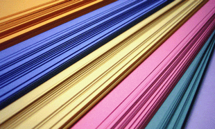 A stack of paper, with orange, blue, yellow, pink, green, and purple pieces.