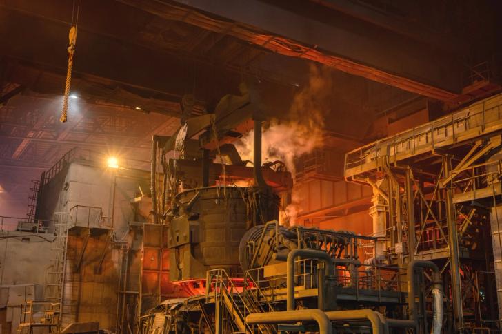 Loading scrap metal into electric arc furnace