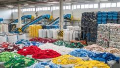 Colourful sorted textiles at Fashion For Good's sorting centre