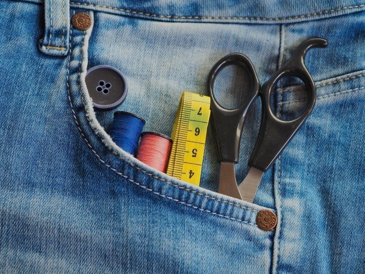 Jeans with sewing equipment in pocket