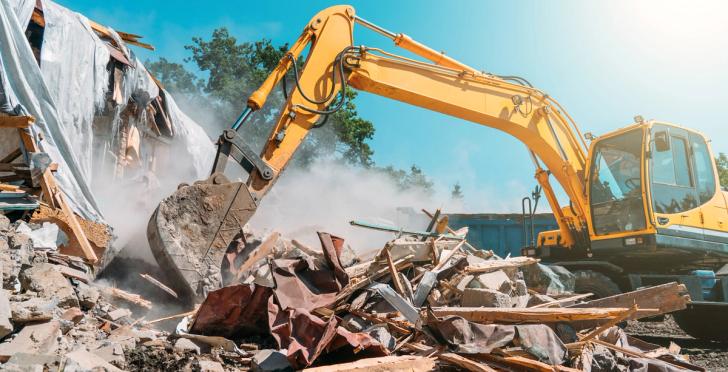 An excavator managing construction waste