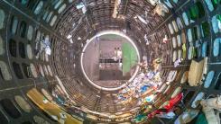 Photo looking inside a circular trommel screen with mixed household waste being spun