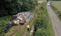 Aerial view of officers assessing flytipped waste