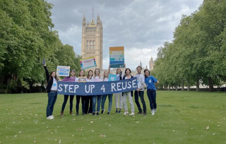 CityToSea campaigners stood in a park holding banners to promote World Reuse Day