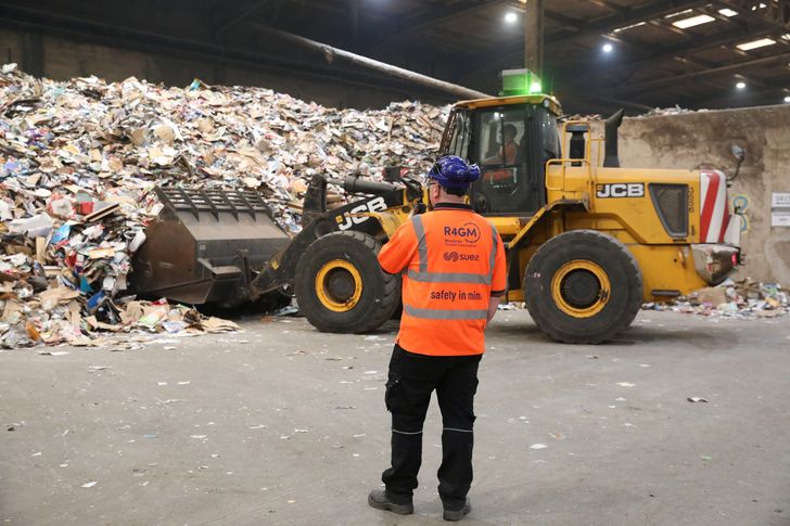 Waste from Greater Manchester area managed by a JCB in the tipping hall at a Suez facility