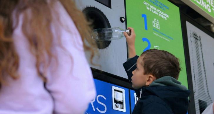 Boy using a reverse vending machine