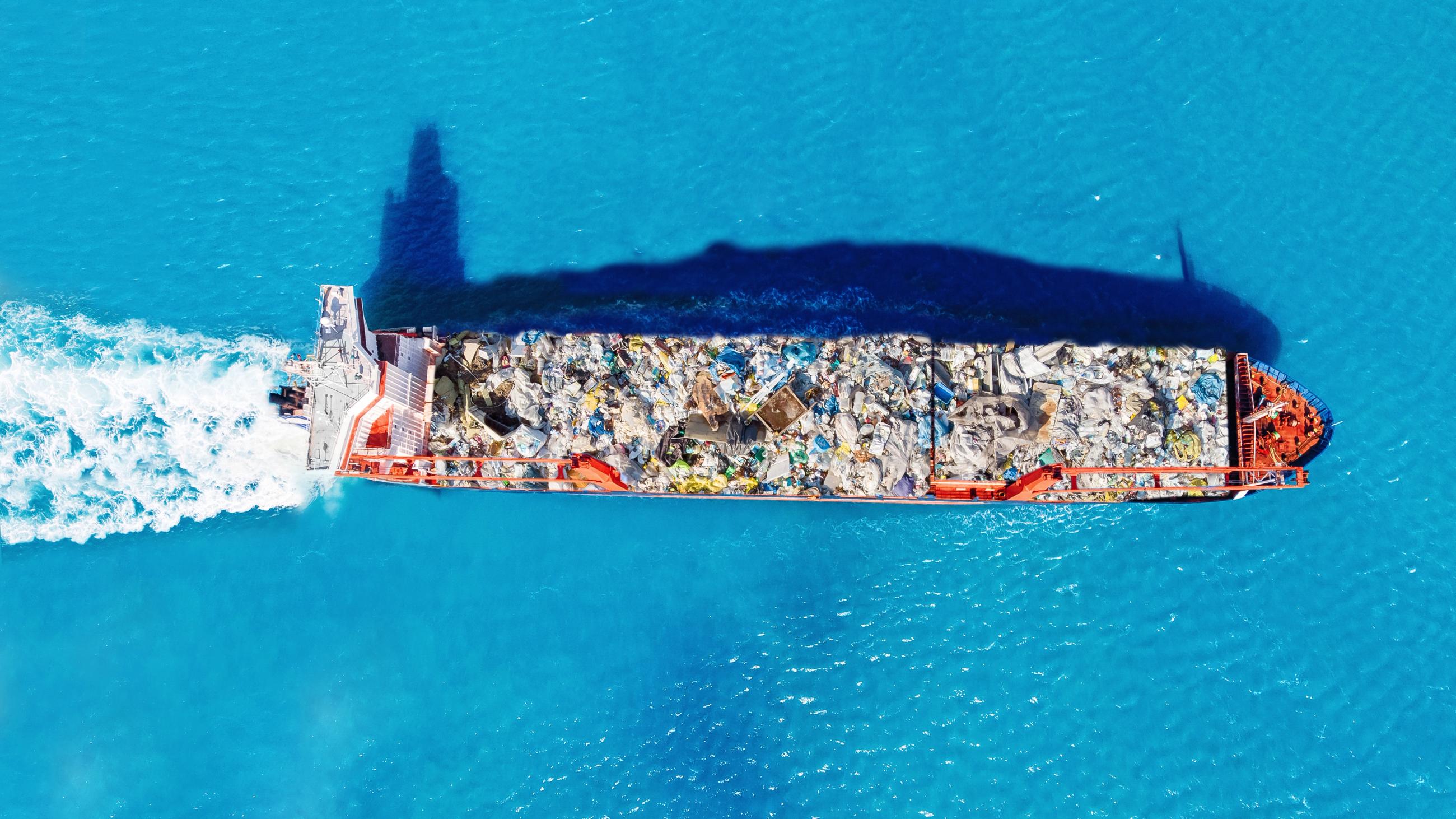 Aerial view of a ship carrying waste across the sea