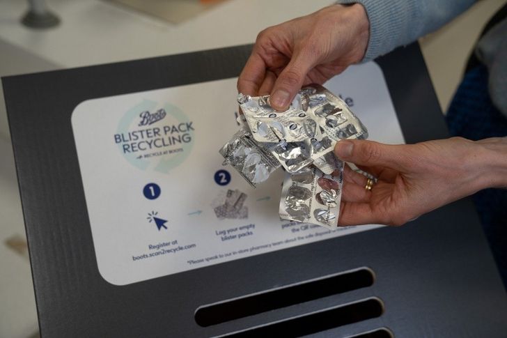 Blister packs being deposited in Boots return box