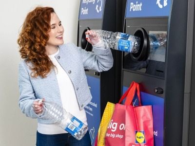 Person using a reverse vending machine