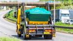 Skip truck transporting waste on a UK road