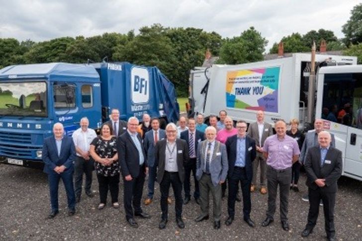 A crowd of people from SUEZ and Doncaster Council, in front of waste collection lorries