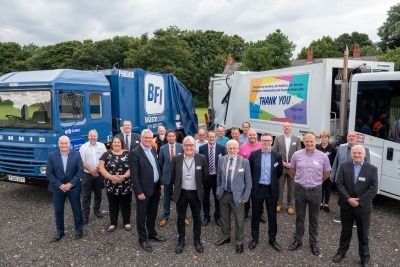 A crowd of people from SUEZ and Doncaster Council, in front of waste collection lorries