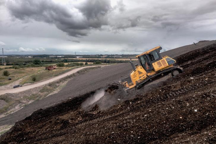 Bulldozer on slope of an inert landfill