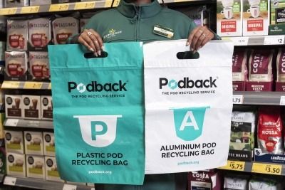 Morrisons employee holding Podback collection bags