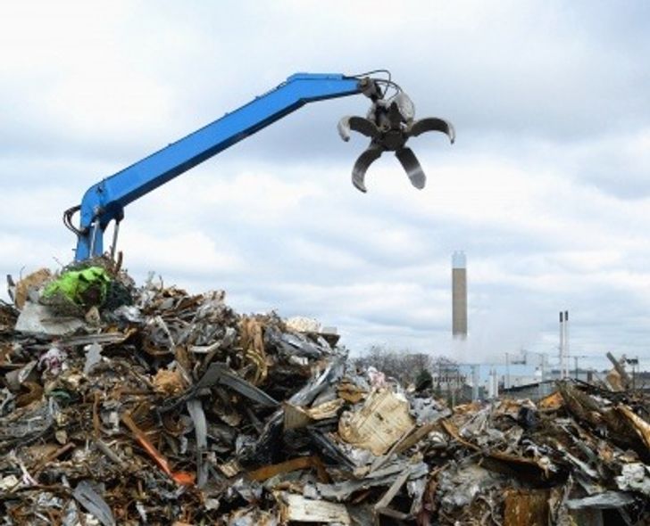 Construction waste being moved by a telehandler