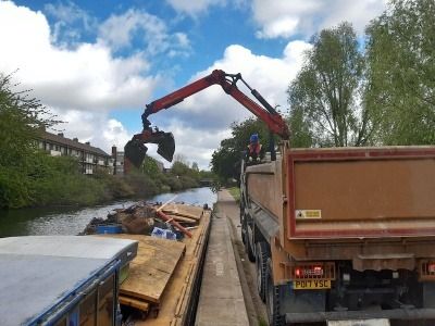 A machine collecting waste from a canal