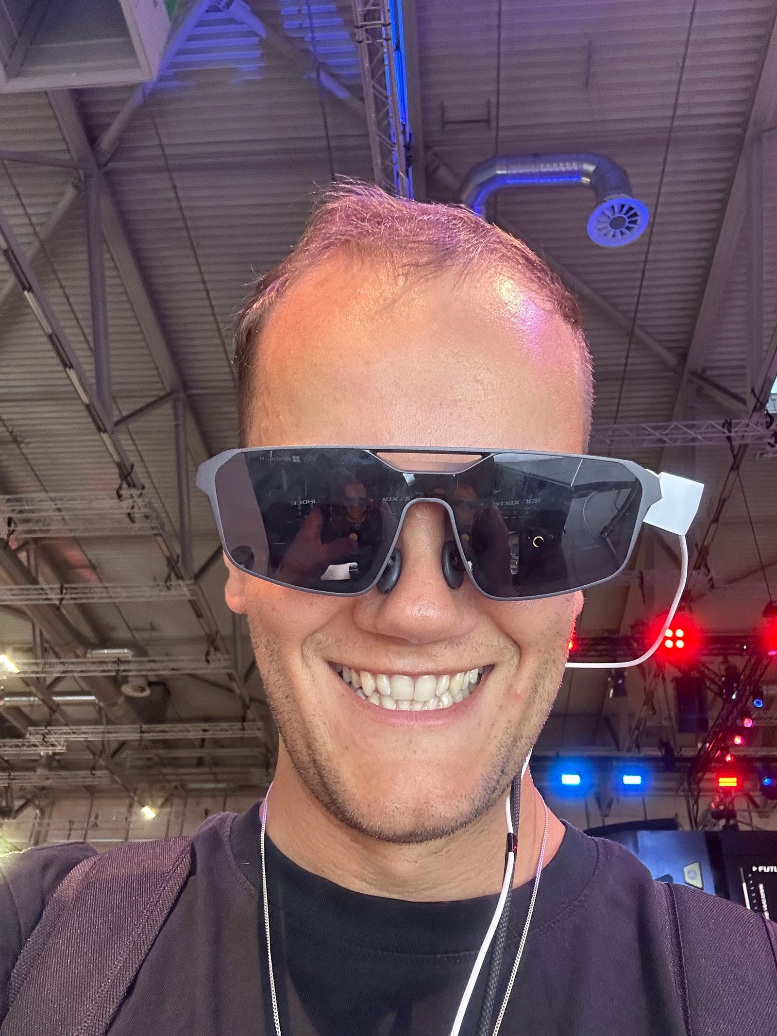 Wearing the XREAL Air glasses in the tech hall.