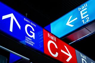 direction signs light boxes in an airport hall