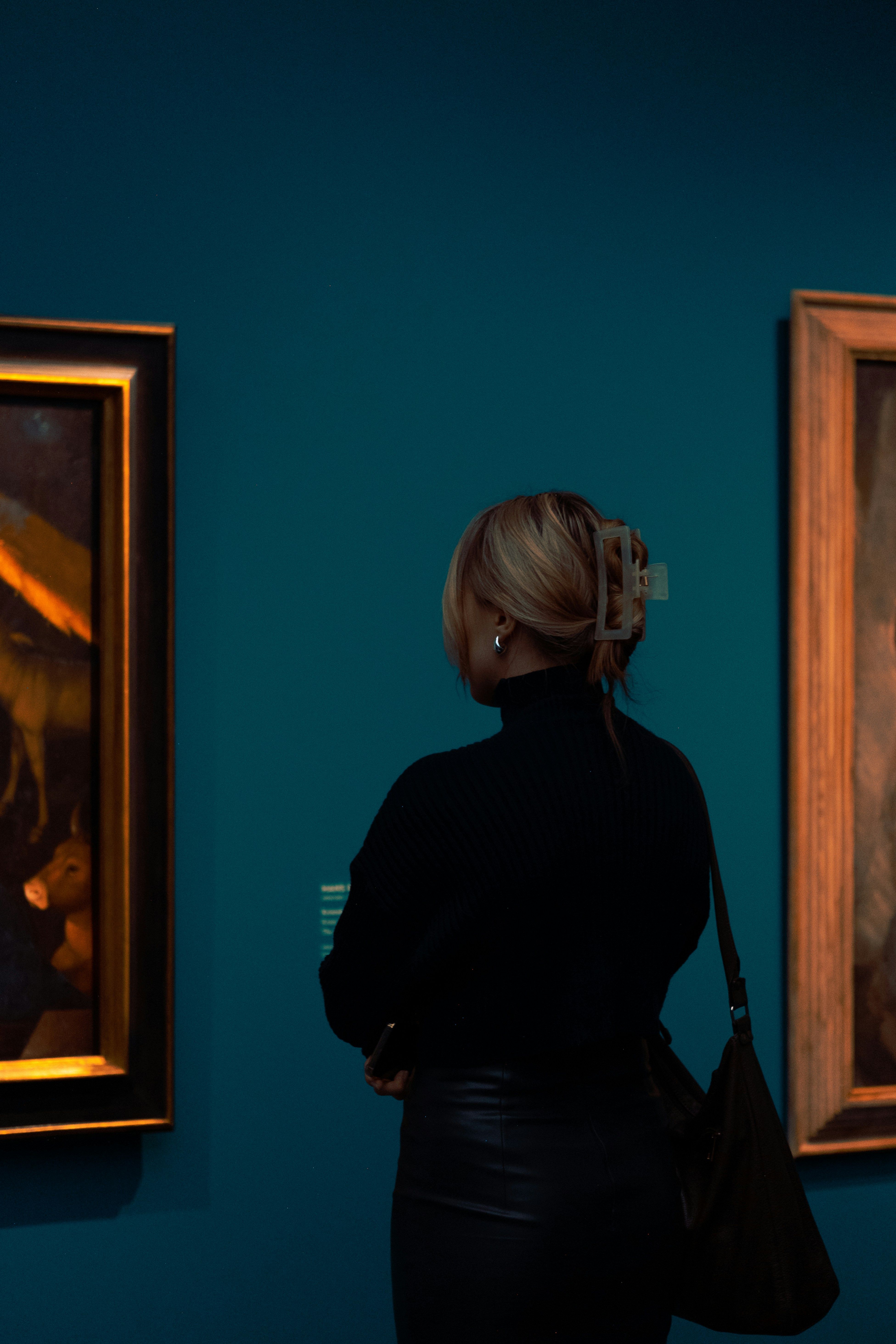 a person looking at art in a museum