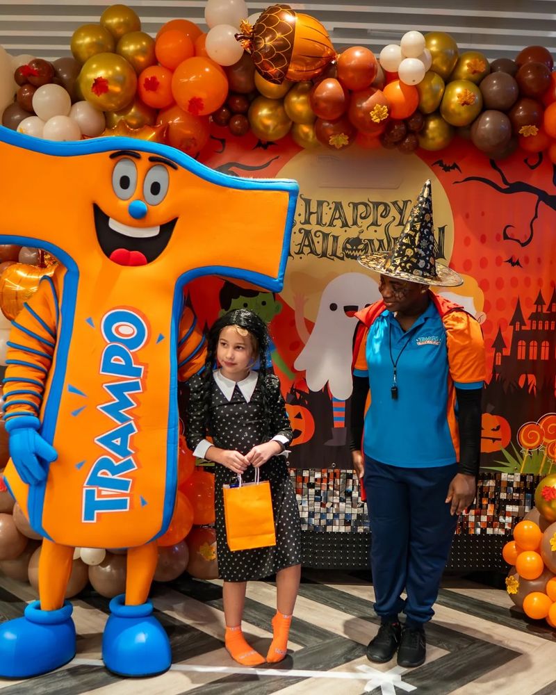 The Trampo mascot with a child in costume