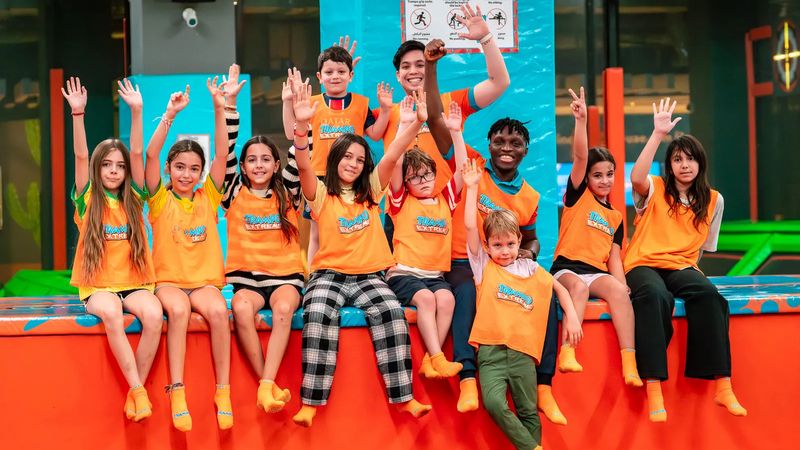 Kids with hands up at Trampo summer camp in Dubai