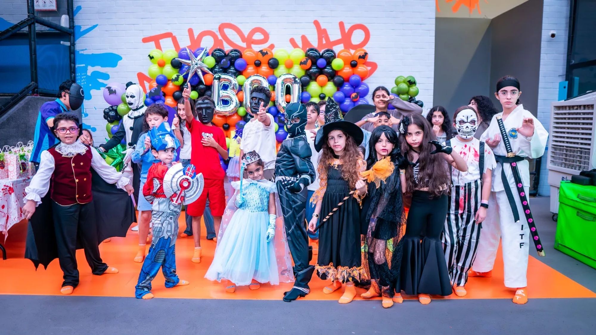 Kids in Halloween costumes at the Trampo Halloween Party