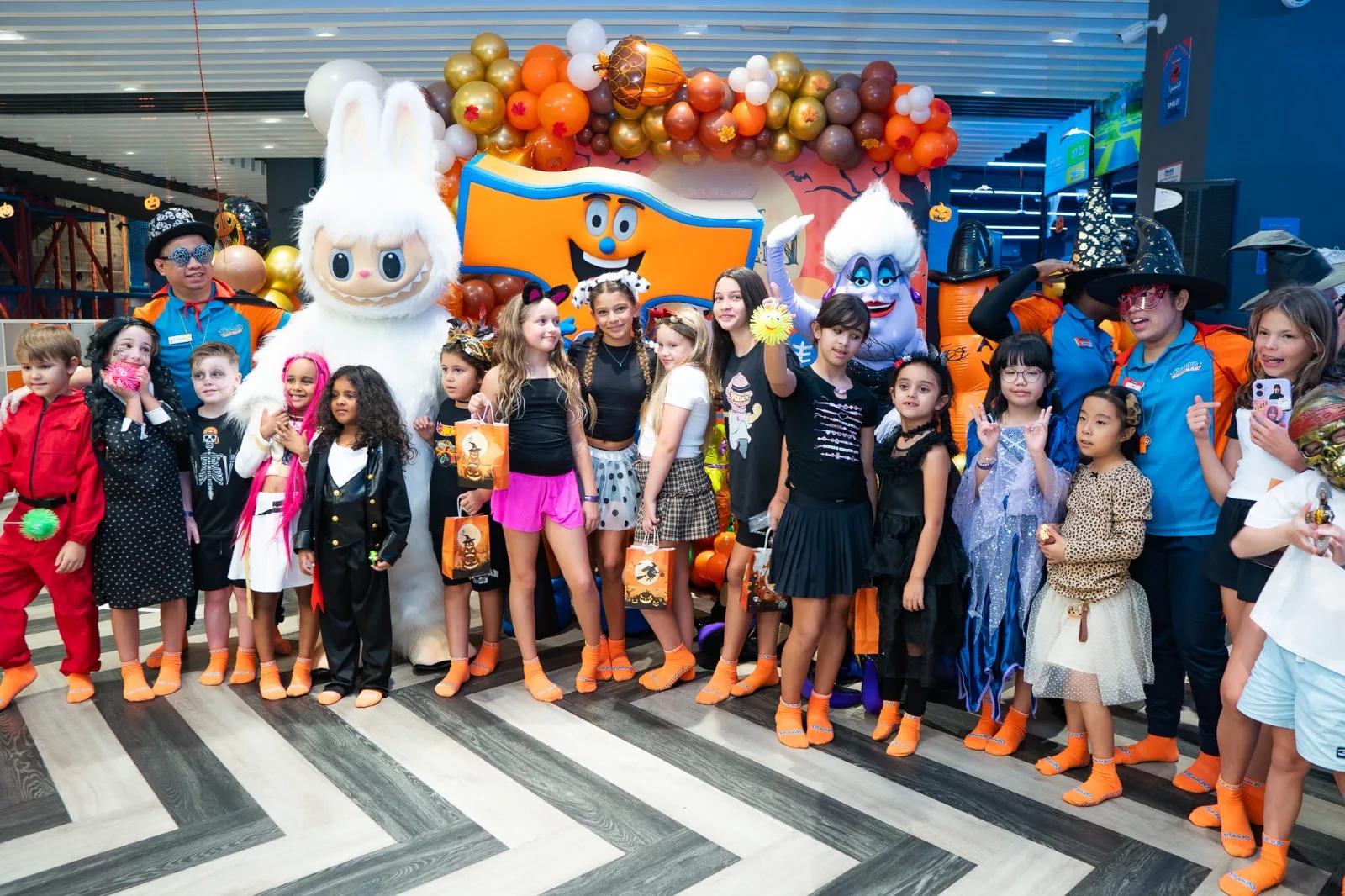 Kids in costumes with the Trampo mascots