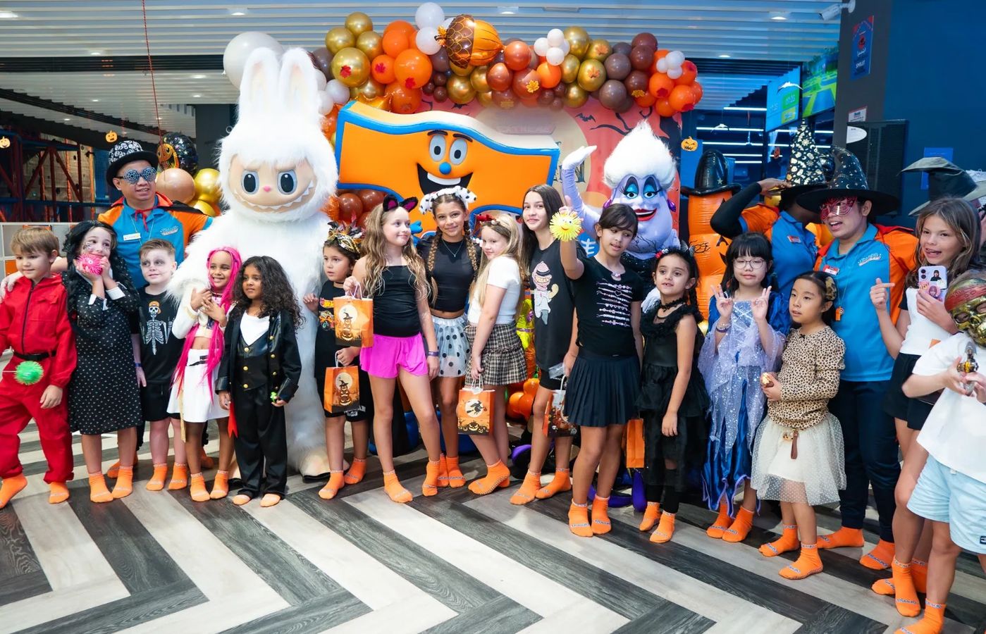 Kids in costumes with the Trampo mascots