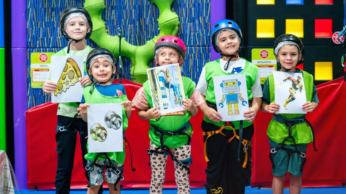 Kids at Trampo UAE indoor wall climbing activity