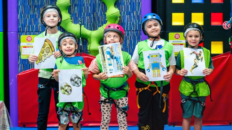 Kids at Trampo UAE indoor wall climbing activity