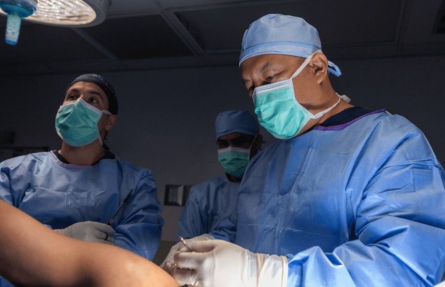 Dr. James Chen, one of the top orthopedic surgeons in the USA, prepares for surgery in the OR