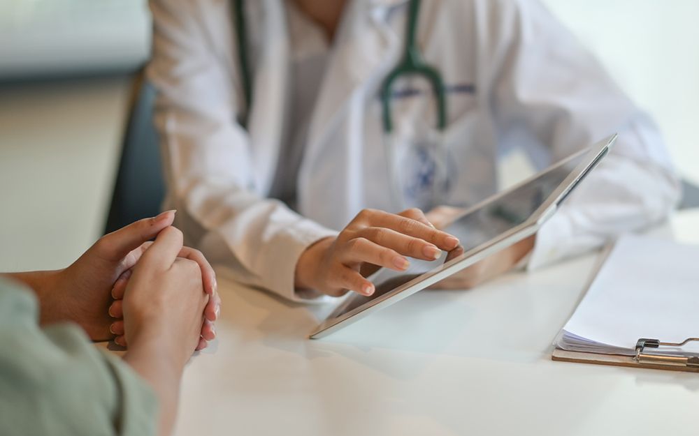 Closeup of second opinion doctor consulting with patient about orthopedic diagnosis in San Francisco