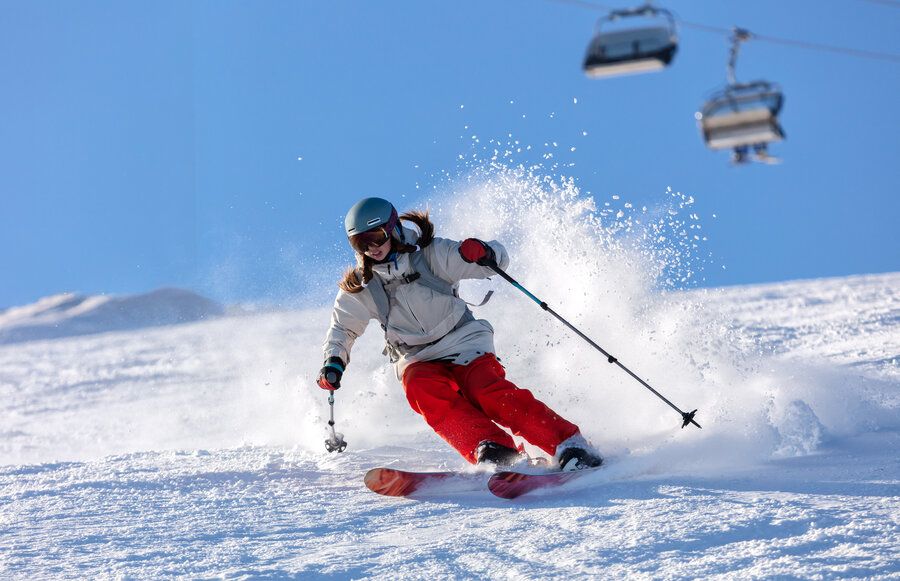 Woman is snow skiing which could be a risk for a femur fracture