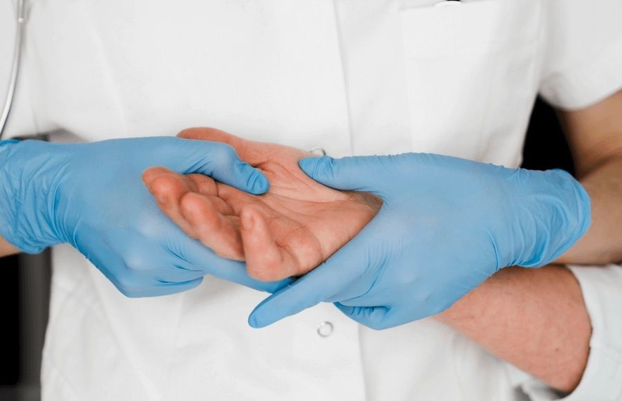 A medical professional examines a patient’s hand and wrist at the best orthopedic surgeon in San Francisco