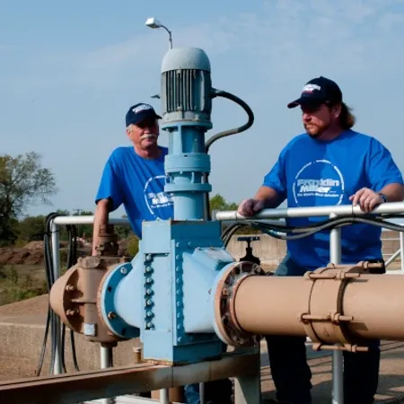 men with taskmaster grinder outside