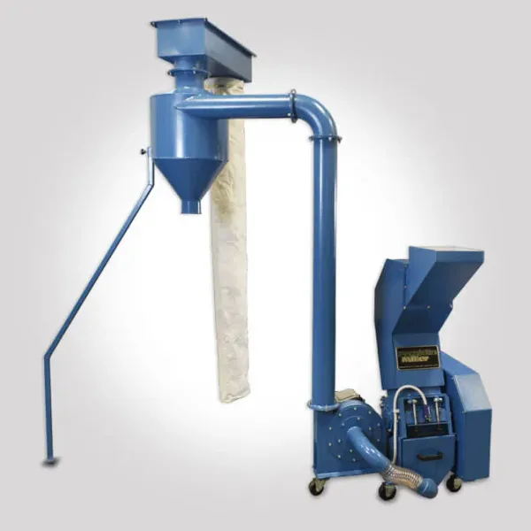 An industrial knife mill with a discharge system attachment