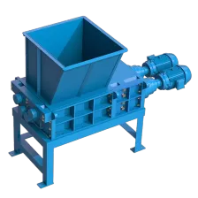 The Taskmaster QS3200 Quad Shaft Shredder, seen here with a hopper, is a high capacity powerful shredder can significantly downsize tough materials.