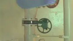 pipes and wheel on wall machine