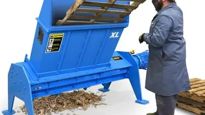 man operating pallet shredder