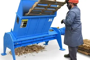 man operating pallet shredder