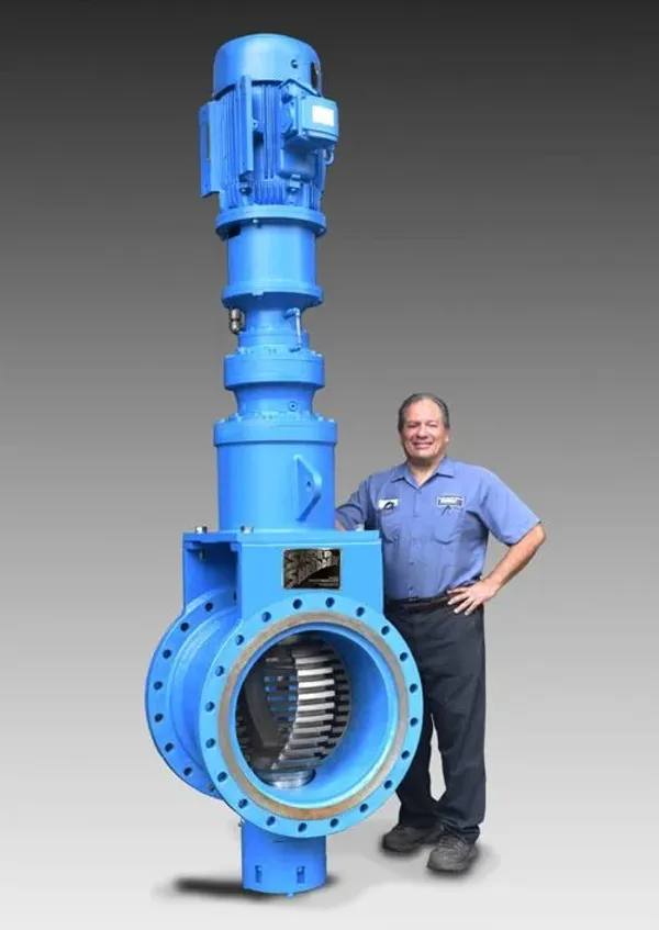 A man standing next to a large grinder