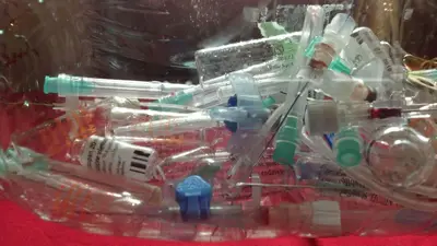 pile of disposed medical syringes