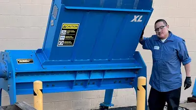 man with large pallet shredder