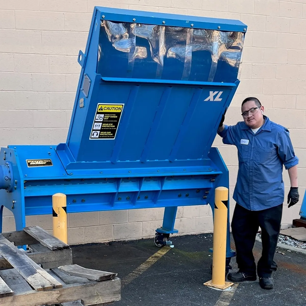 man with large pallet shredder