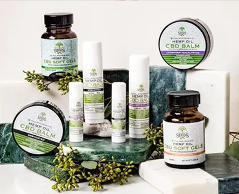 A display of different CBD products in varying bottles, tubs and tubes