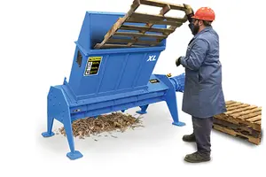 man shredding pallet in blue machine