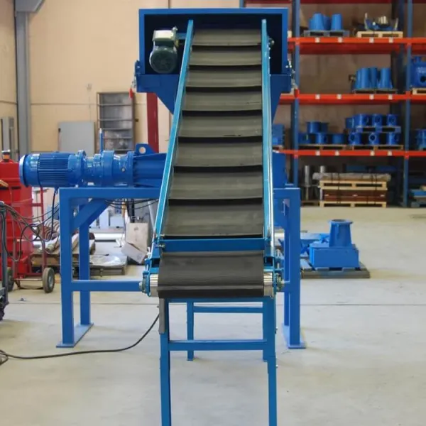 An industrial document shredder sitting in a warehouse with a conveyor