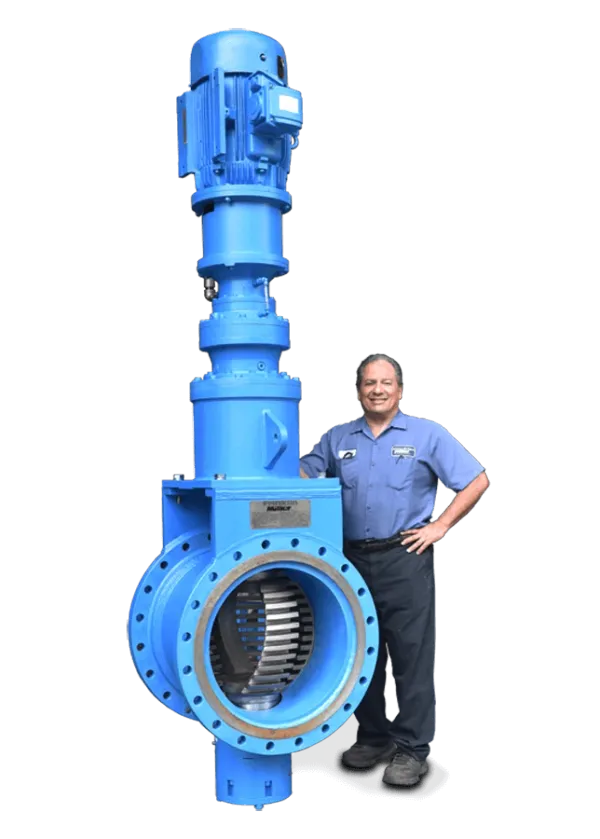 A man standing next to a large industrial grinder